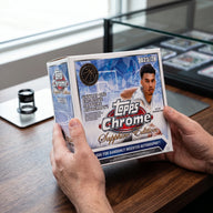 Collector hands displaying 2023-24 Topps Chrome Basketball Sapphire Edition Hobby Trading Cards on a premium card-shop desk.