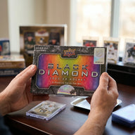 Collector hands displaying 2023-24 Upper Deck Black Diamond Hockey Trading Cards on a premium card-shop desk.