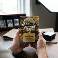 Collector hands displaying 2025 Leaf Metal Sports Heroes Solo Edition Trading Cards on a premium card-shop desk.