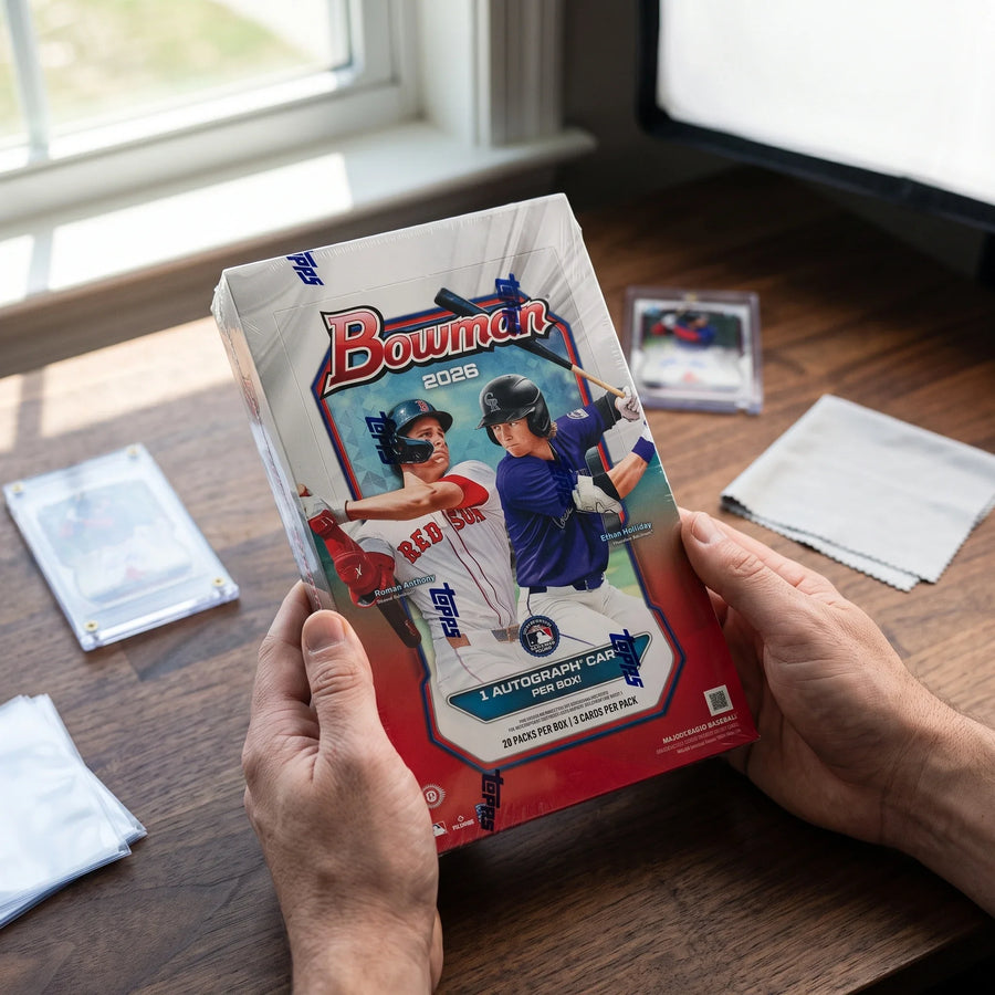 Collector hands displaying 2026 Topps Bowman Baseball Hobby Trading Cards LV on a premium card-shop desk.