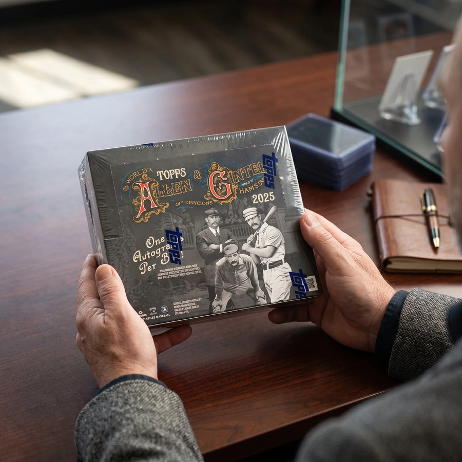 Collector hands displaying 2025 Topps Allen Ginter X Baseball Hobby Case 12 Boxes (Ships Sealed Only) on a premium card-shop desk.