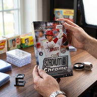 Collector hands displaying 2022 Topps Stadium Club Chrome Baseball Hobby Box (Ships Sealed Only) on a premium card-shop desk.
