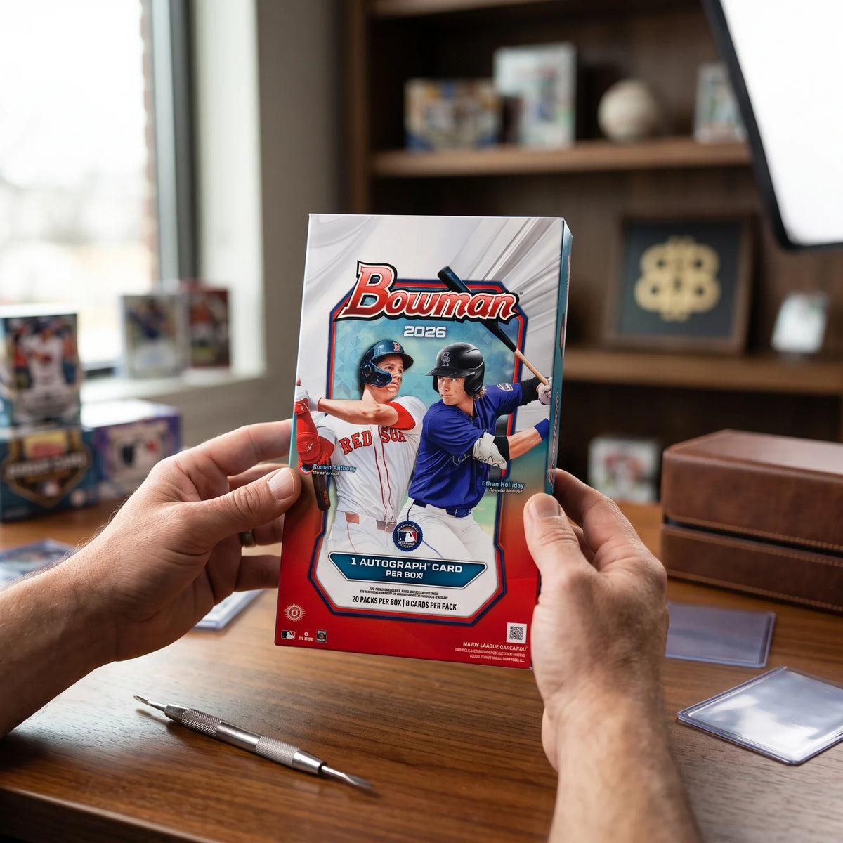 Collector hands displaying RIP TIL YOU HIT | 2026 Bowman Baseball Hobby | 1st Bowman Chase on a premium card-shop desk.