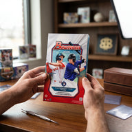 Collector hands displaying RIP TIL YOU HIT | 2026 Bowman Baseball Hobby | 1st Bowman Chase on a premium card-shop desk.