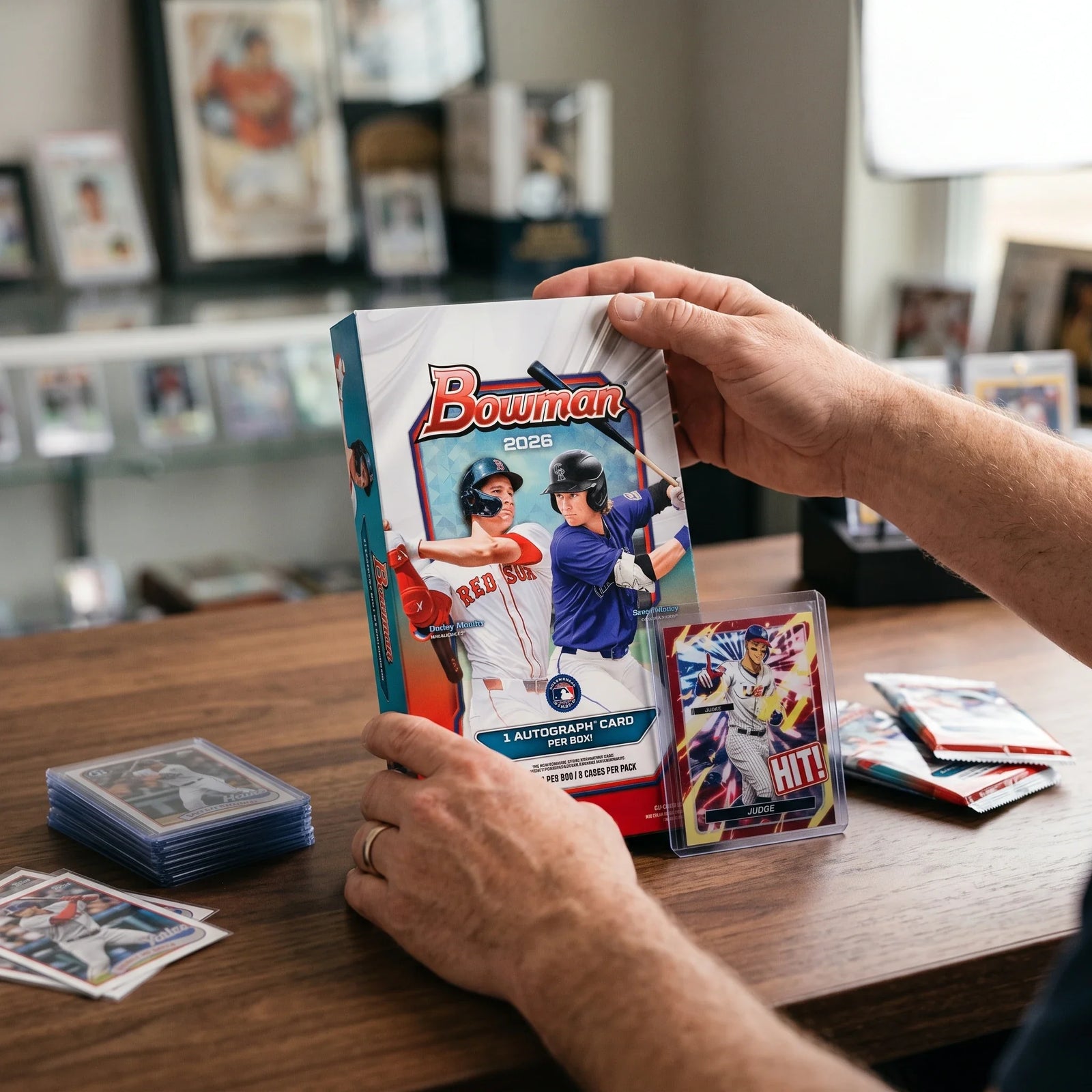 Collector hands displaying RIP TIL YOU HIT | 2026 Bowman Baseball Hobby | $199.95 | 1st Bowman Chase LV on a premium card-shop desk.